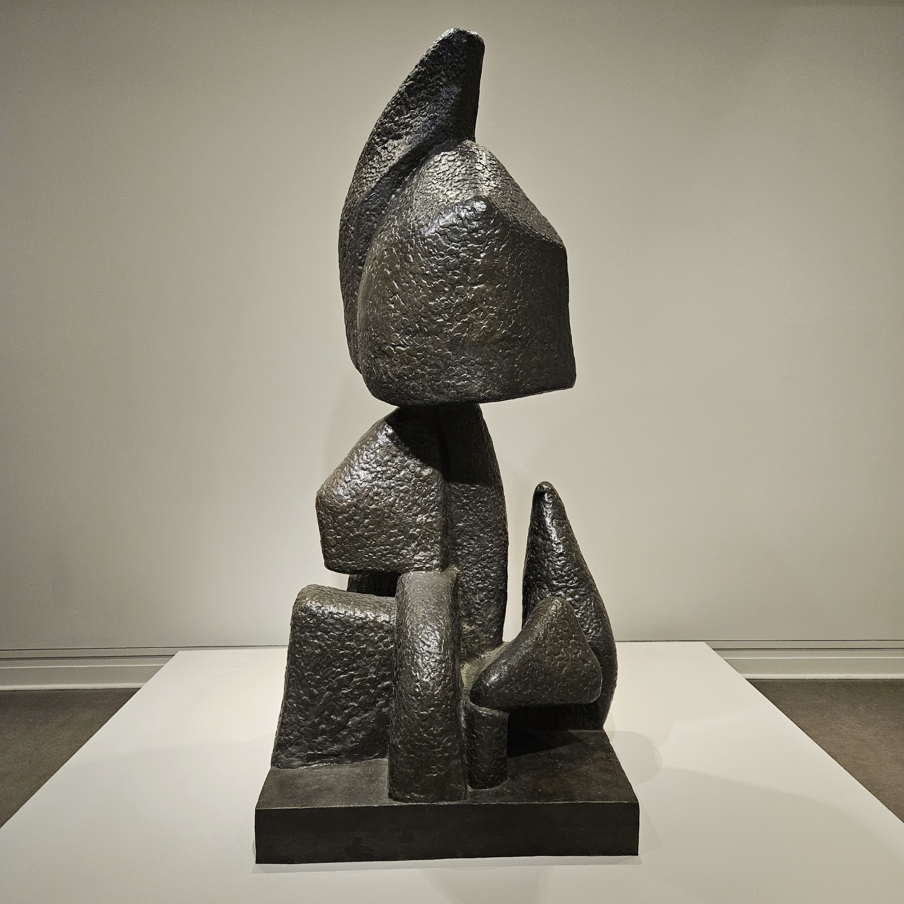 A large bronze sculpture made of textured forms of different shapes.